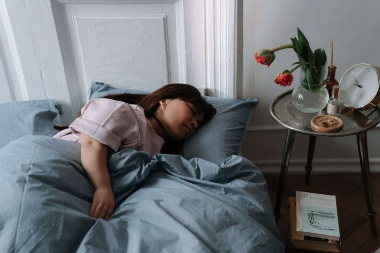 Kvinna sover på sidan i en säng
